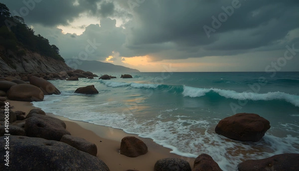 Obraz Serene rocky coast moody with dark clouds and teal ocean during sunset