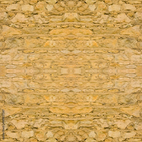 Fototapeta An old yellow wall made of stone and cement. Yellow, stone background. Ancient ruins. Stone texture. Seamless image. Symmetrical.