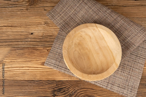 Obraz Empty wood bowl on table, plate on wooden table and tablecloth, light rustic dish mockup