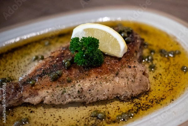 Fototapeta Sole meunière, classic French dish of pan-fried sole in butter with lemon and parsley