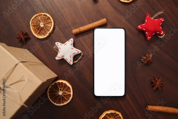 Obraz flat lay with smarthone and christmas decorations on walnut table