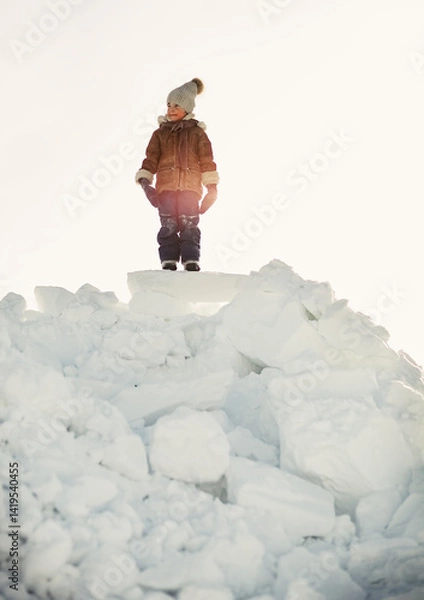 Obraz The boy climbed a mountain of snow blocks
