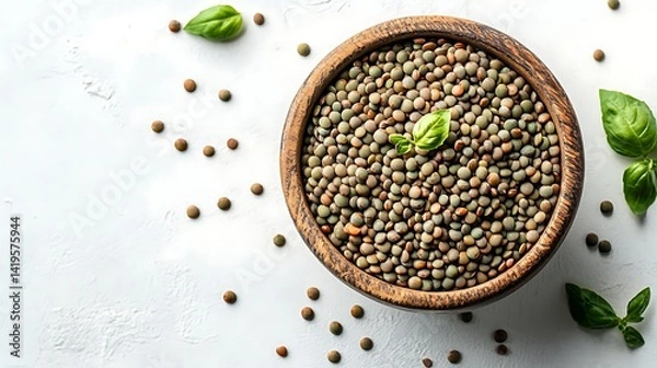 Fototapeta Overhead View Of Lentils In A Wooden Bowl With Basil Leaves On A White Textured Surface Perfect For Healthy Eating And Vegetarian Lifestyle