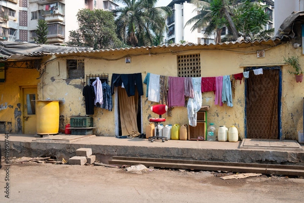Obraz Clothes hanging for to dry on the clothesline, old aged house facade in India, lifestyle and culture, decaying wall