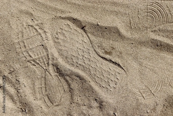 Obraz A close view of the footprint in the sandy surface.