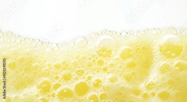 Fototapeta A yellow beer foam background with white bubbles, white space at the top of the frame
