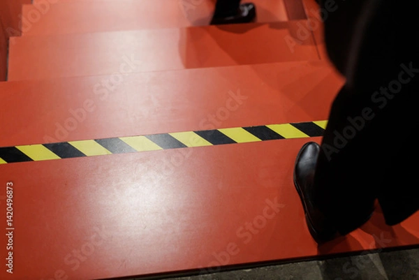 Fototapeta Steps leading down with caution tape, showing the importance of safety in public spaces