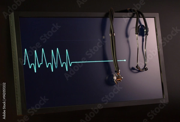 Obraz Fading cardiogram and stethoscope on the monitor