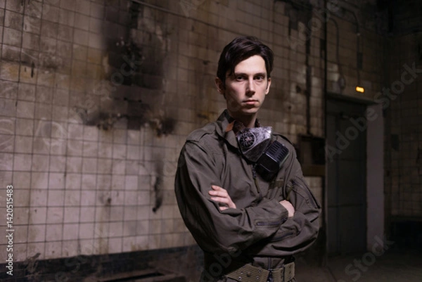 Fototapeta Post-apocalyptic warrior in military jumpsuit with respirator, gritty environmental portrait