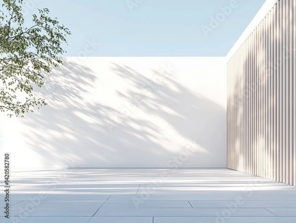 Obraz A white building with a white wall and a white fence. The fence is made of wood. There is a tree in the background