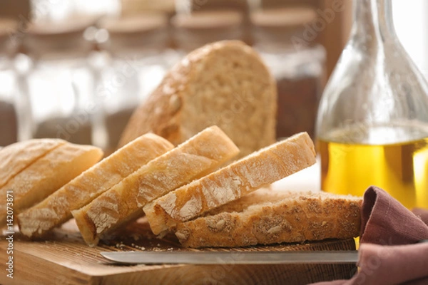 Obraz Cut bread and knife on kitchen board