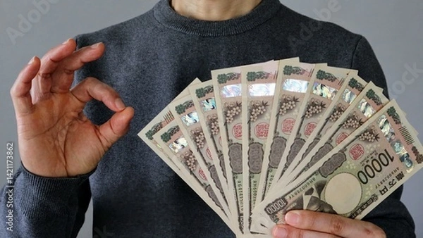 Obraz 大量の一万円札を持ちポーズする人物