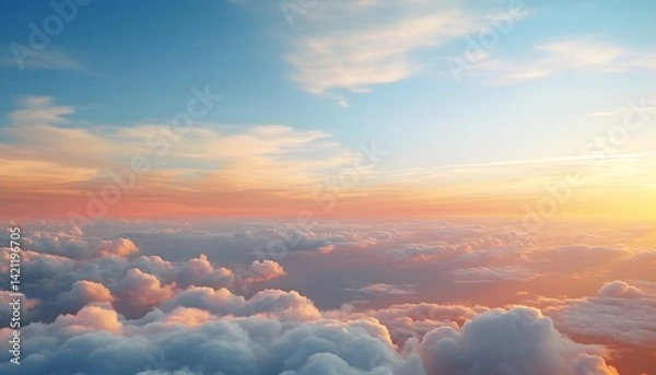 Fototapeta Beautiful sunset scene showing a vast sky filled with soft fluffy clouds illuminated by warm orange and pink sunlight, creating a peaceful and glowing atmosphere above the horizon