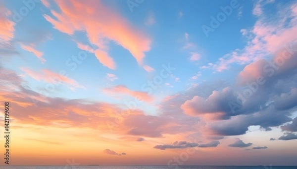 Fototapeta Beautiful sunset clouds illuminated by warm sunlight, showing soft orange and pink colors blending with the blue sky for a calm and serene evening atmosphere