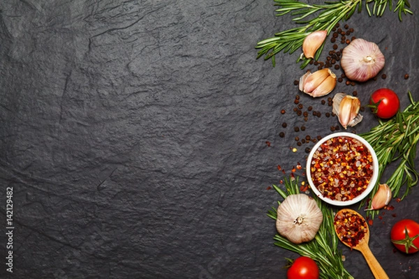 Fototapeta Colorful spices in spoons and tomatoes on dark vintage background. Top view. Food and cuisine ingredients.