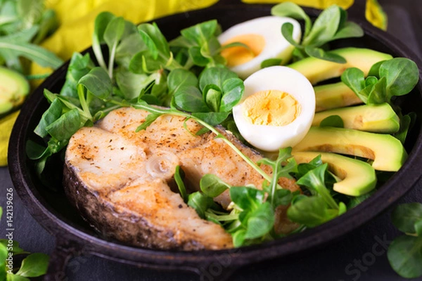 Obraz Grilled sheatfish fish steak with avocado, arugula and salad