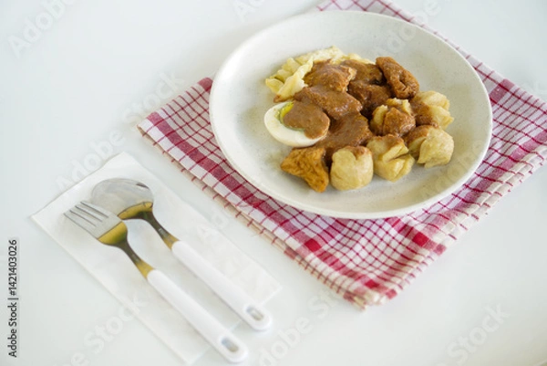 Fototapeta Batagor or better known as bakso, fried tofu, is a typical snack from Bandung, Indonesia. This food is served with peanut sauce and sweet soy sauce plus lime juice.