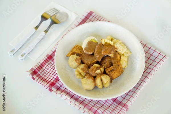 Fototapeta Batagor or better known as bakso, fried tofu, is a typical snack from Bandung, Indonesia. This food is served with peanut sauce and sweet soy sauce plus lime juice.