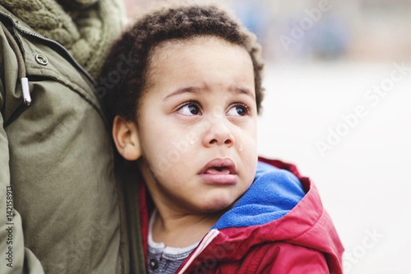 Obraz Portrait of a little upset toddler boy crying.