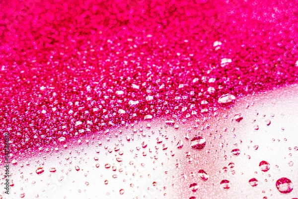 Fototapeta background texture for background bright pink color with shimmers and flowing drops on glass, beautiful bright background with overflows