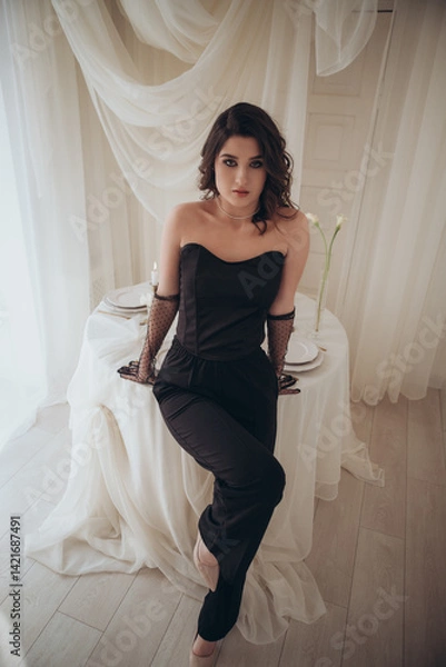 Fototapeta Glamorous woman sitting with candles in moody soft interior
