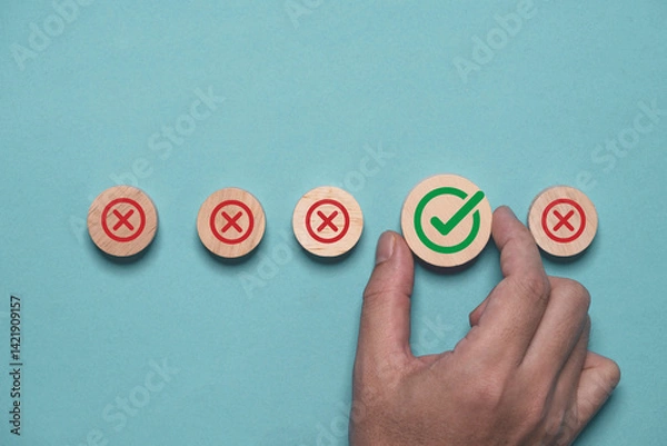Fototapeta Hand holding green correct sign mark among Red Cross mark for business project approval and document approve concept.