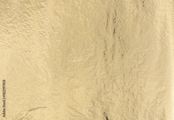 Obraz Golden foil texture with metallic sheen creates a chic, subtle finish. Reflective surface with soft light highlights the sleek, polished design. Perfect for luxury wrapping, decorative art, and.