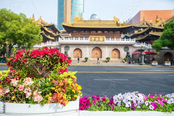 Fototapeta Colorful flowers decor by street with Jingan temple, Shanghai, China