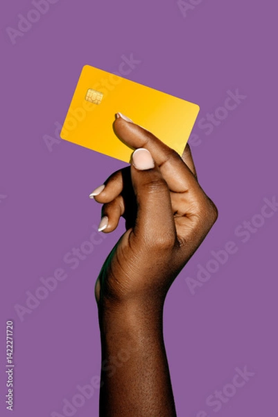 Obraz beautiful Black afican female Hand holding blank yellow atm credit card tempplate with isolated over purple background