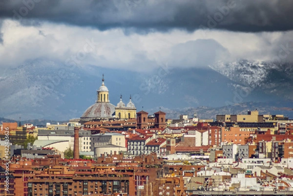 Fototapeta Panoramic view of Madrid, the capital of Spain, with the partially snow-covered mountains in the background.