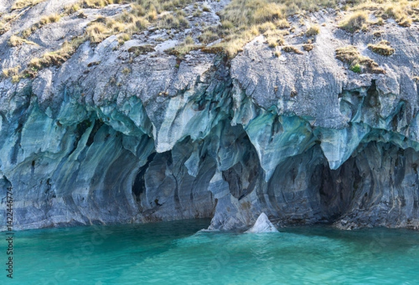 Fototapeta Interior of the flooded Marble Caves, unique rock formations in the General Carrera Lake, Chile. The walls of the caves have swirling mineral patterns. Turquoise water fills the caves with blue light.