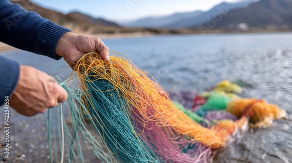 Fototapeta Ocean conservation plastic balanceperson holds colorful plastic strands by ocean highlighting conservation efforts for environmental balance