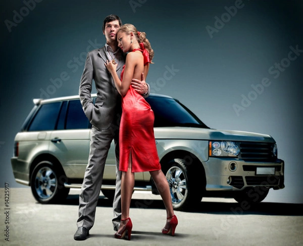 Obraz Young beautiful couple backdrop car