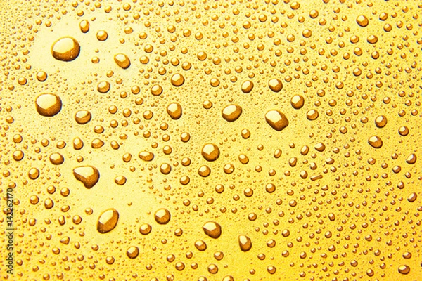 Fototapeta Drops of water on a color background. Yellow