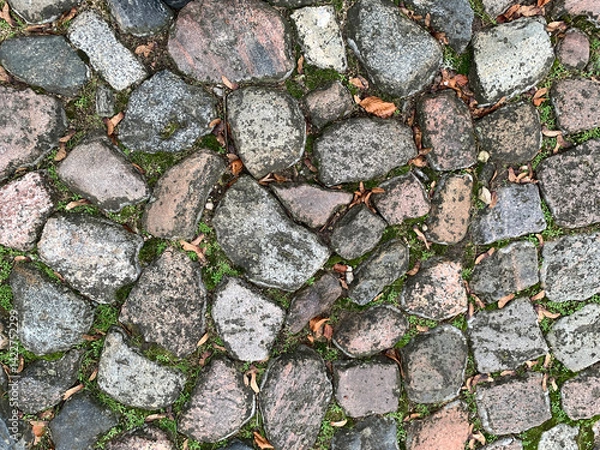 Fototapeta ancient pavement, street paved with multi-colored stones
