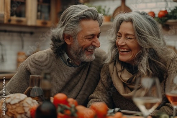 Fototapeta A happy middle-aged couple sitting in the kitchen, creating a cheerful atmosphere of love and happiness for a Valentine's Day celebration.