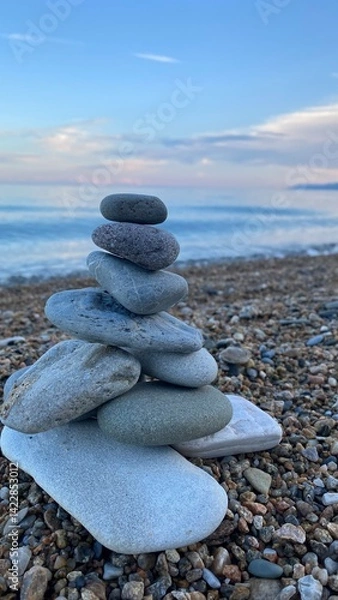Fototapeta a tower of stones on the seashore