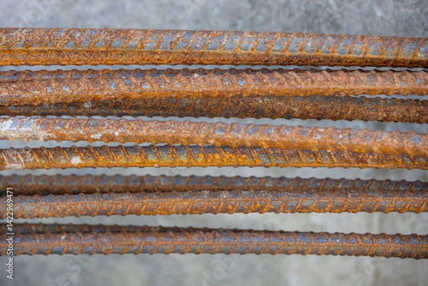 Fototapeta Close-up of a concrete foundation with a steel rebar cage inside, prepared for construction.