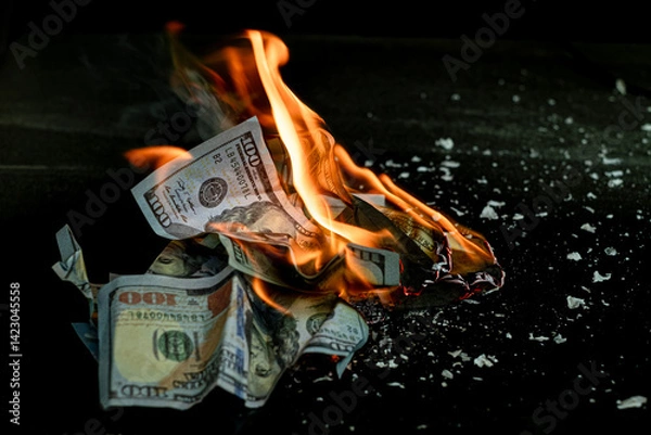 Fototapeta Stack banknote is burning on a black background