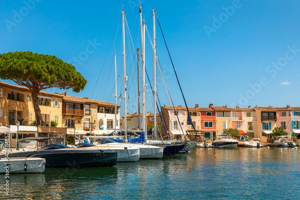 Fototapeta Boats under clear blue sky moored in the harbor of Port Grimaud, France.