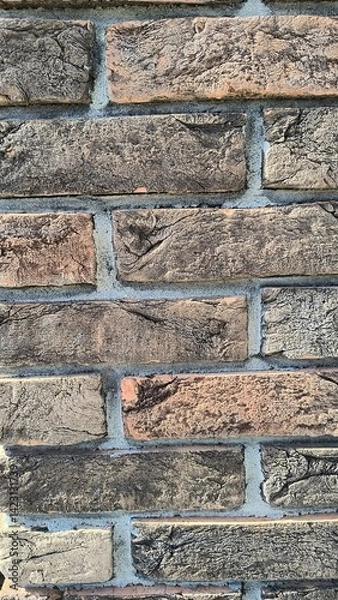 Obraz Textured brick wall showcases earthy tones and unique patterns in urban setting
