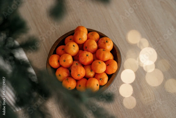 Obraz Fresh tangerines in a plate on a table with lights 