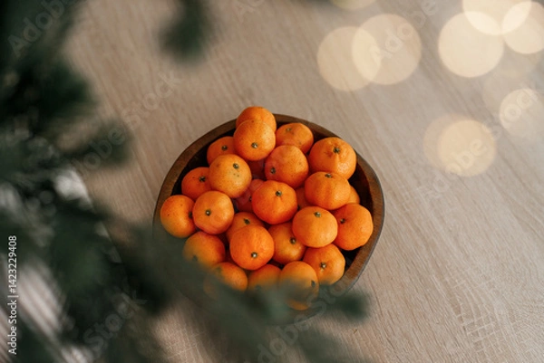 Obraz Fresh tangerines in a plate on a table with lights 