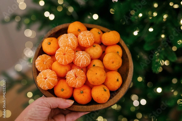 Obraz Plate with tangerines under a beautiful New Year tree. View from above