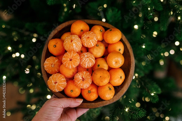 Obraz Plate with tangerines under a beautiful New Year tree. View from above