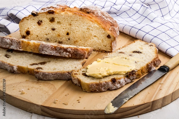 Obraz slice irish raisin soda bread with butter and knife