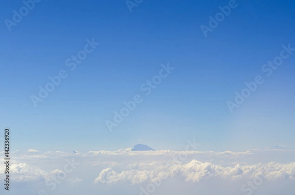 Obraz alpine landscape with peaks covered by snow and clouds