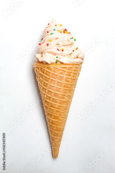 Fototapeta vanilla ice cream cone with sprinkles, isolated on white background