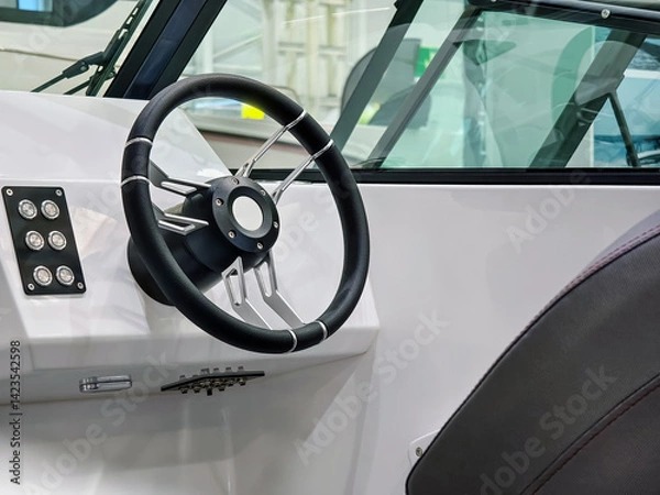 Obraz Modern boat steering console showcasing advanced controls and sleek design in a marine setting
