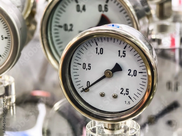 Obraz Pressure gauges displayed in a factory setting showcasing various measurements and dials